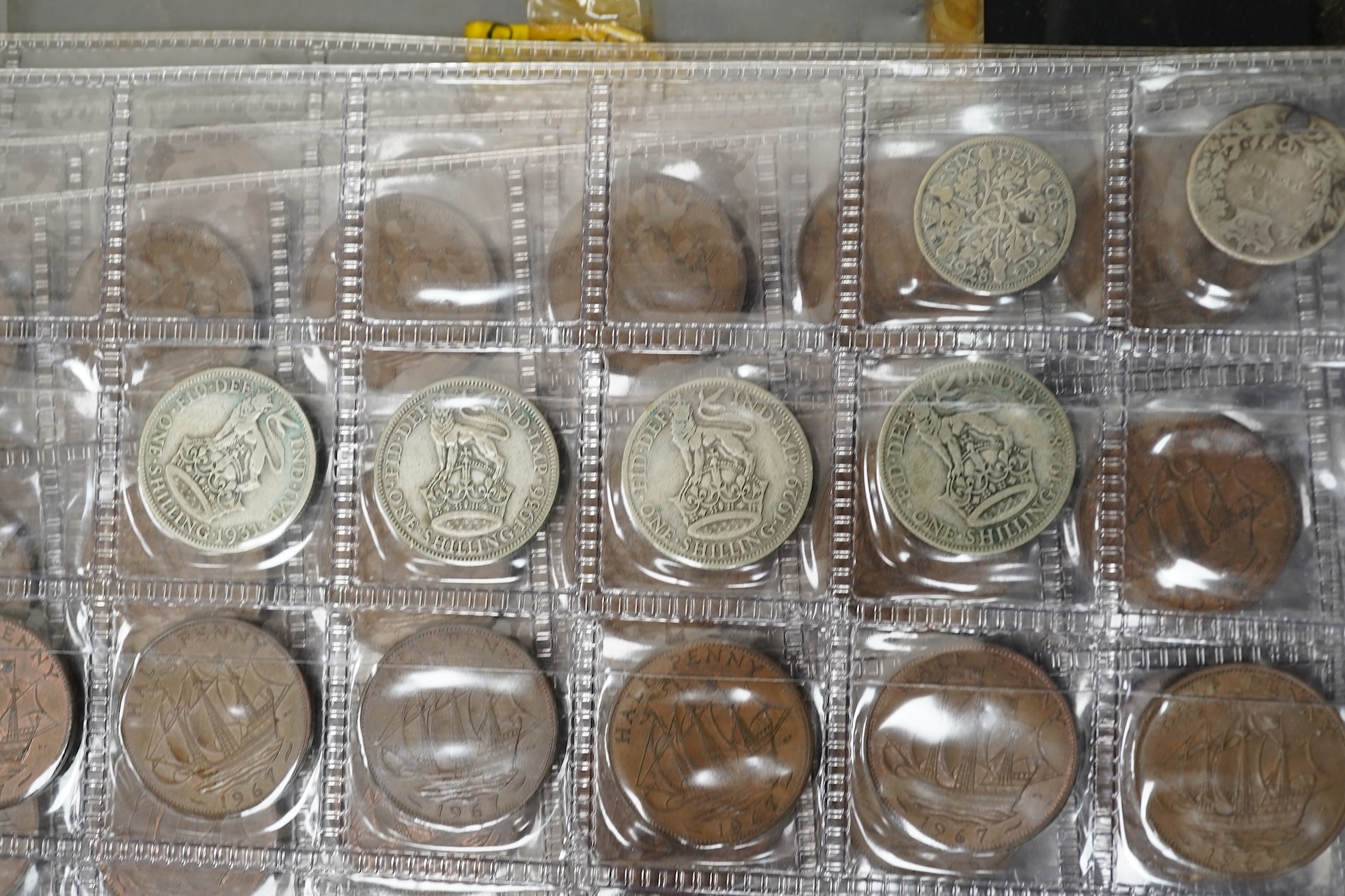 A collection of various coinage in an album, mostly George V to QEII